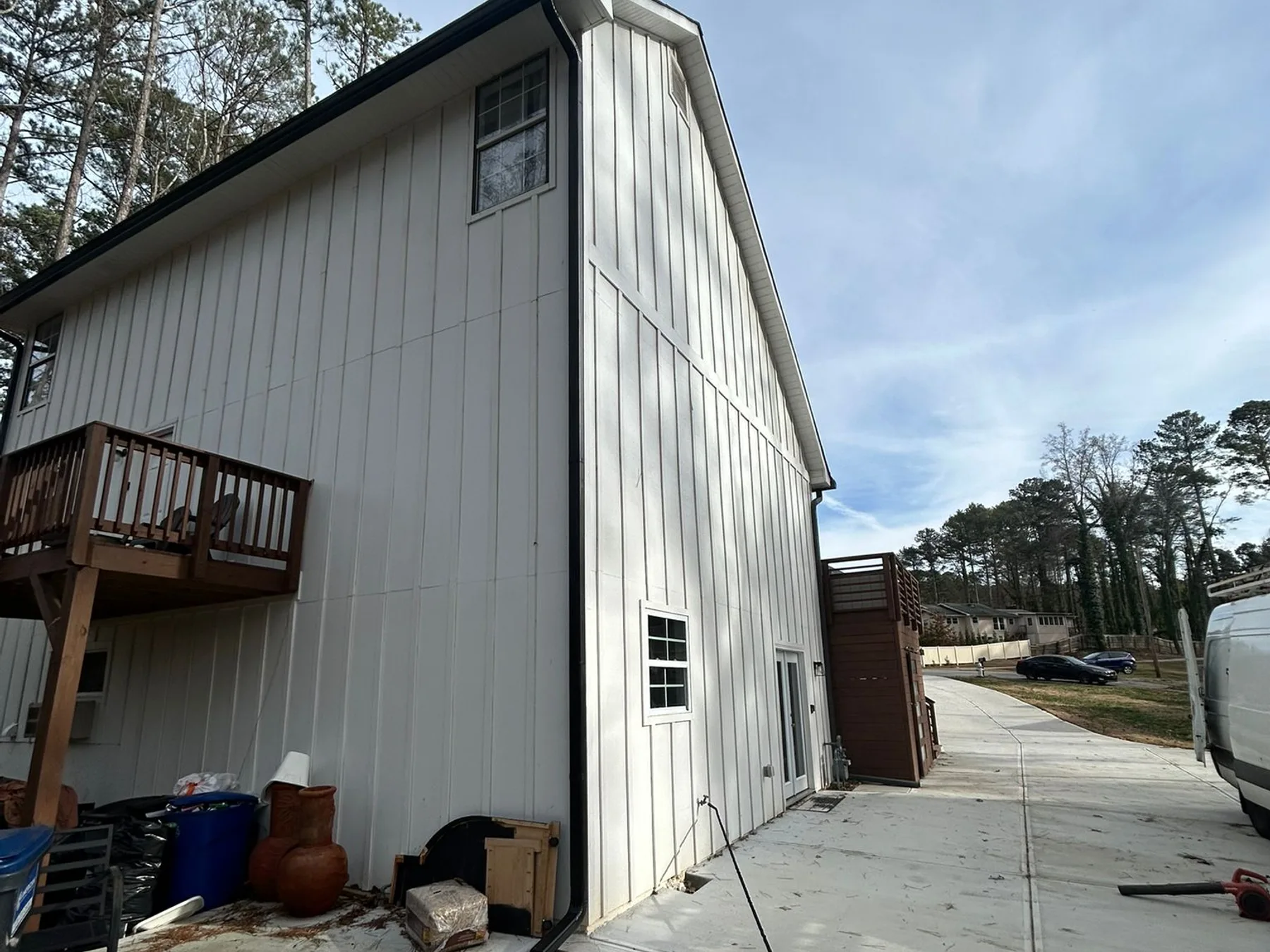 Newly installed seamless gutters on a home with the AJ Gutters LLC service van on-site