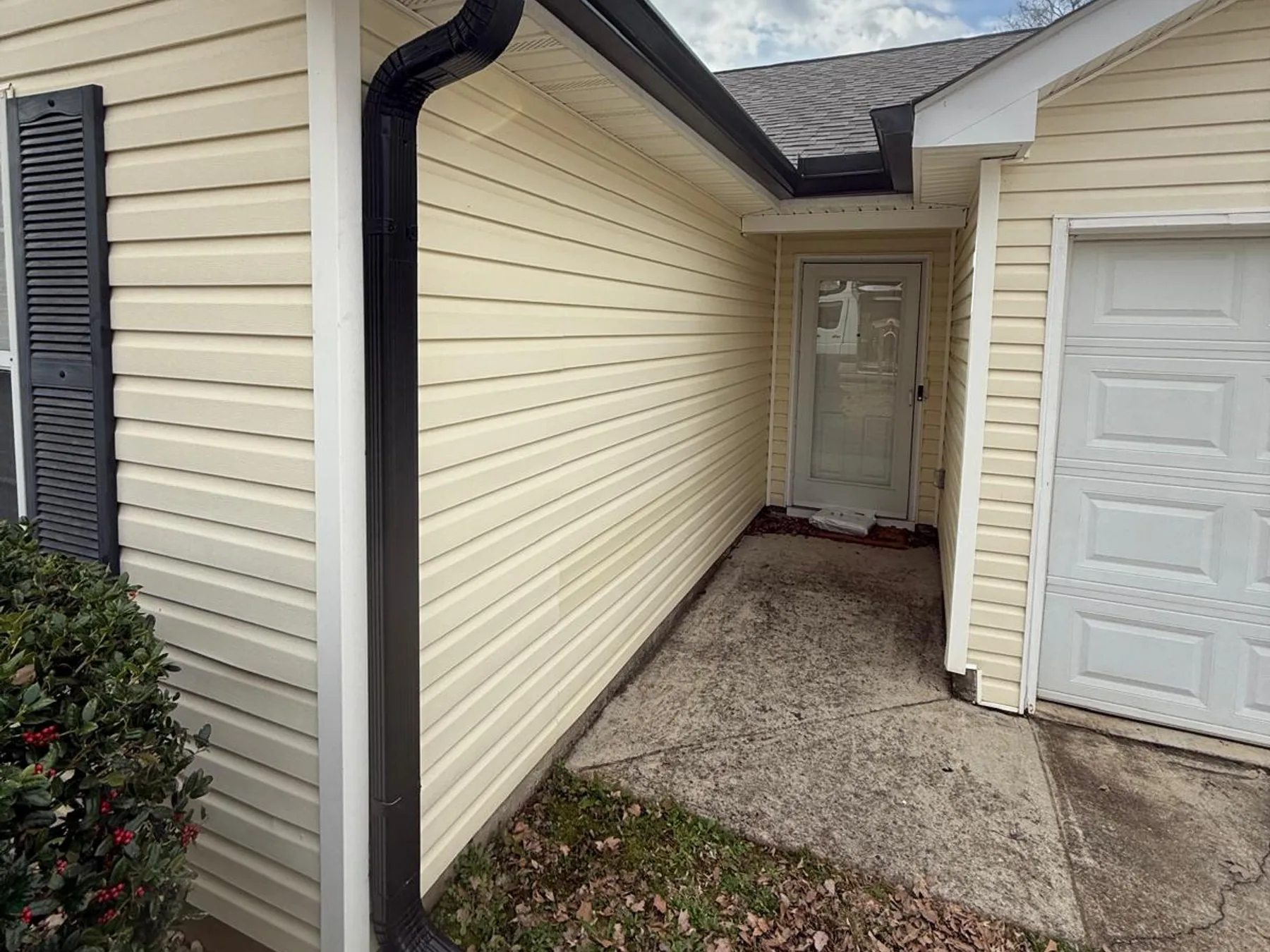 Close-up of a newly installed gutter downspout on a home exterior