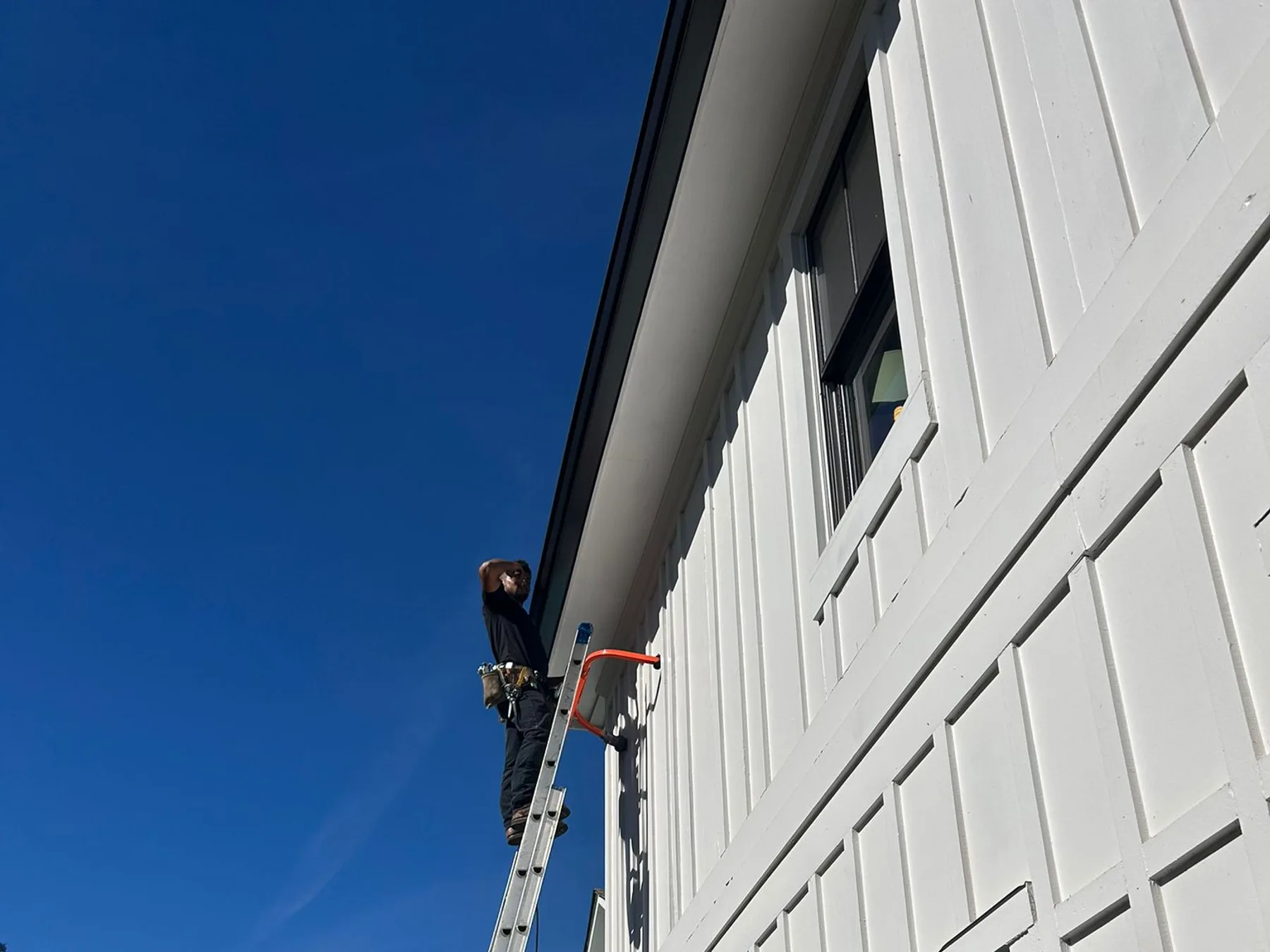 Finished gutters on a cottage-style home with a covered porch
