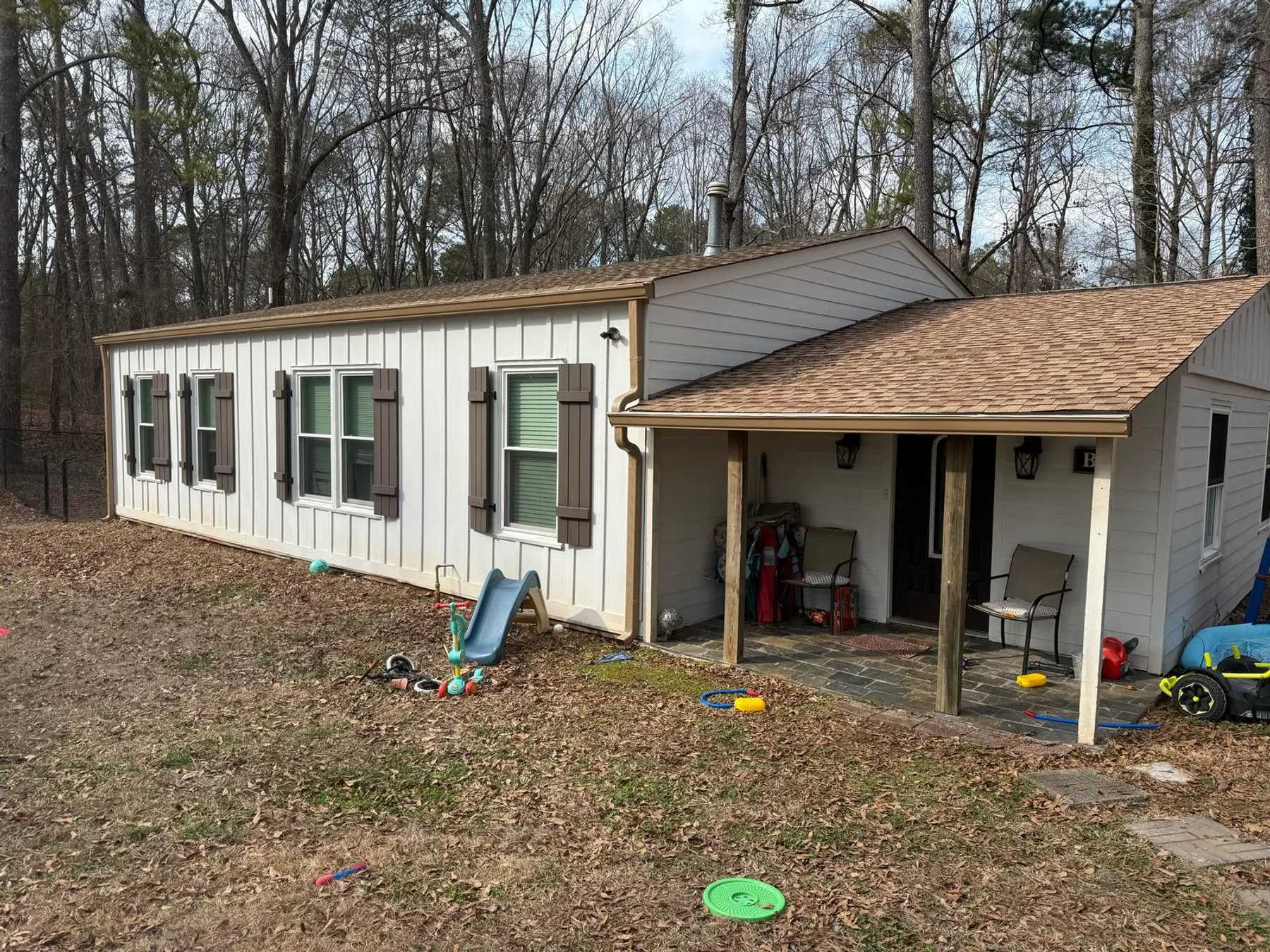 Completed gutter installation on a tan ranch-style home