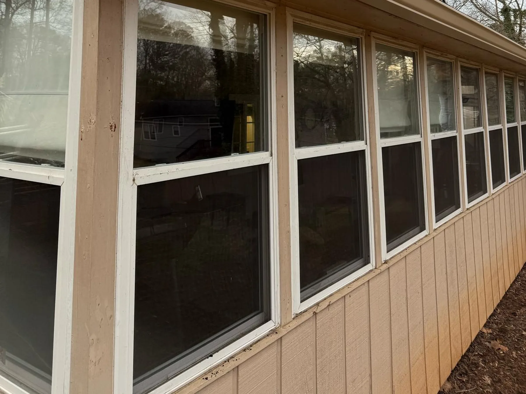 Gutter guard mesh installed along a sunroom roofline