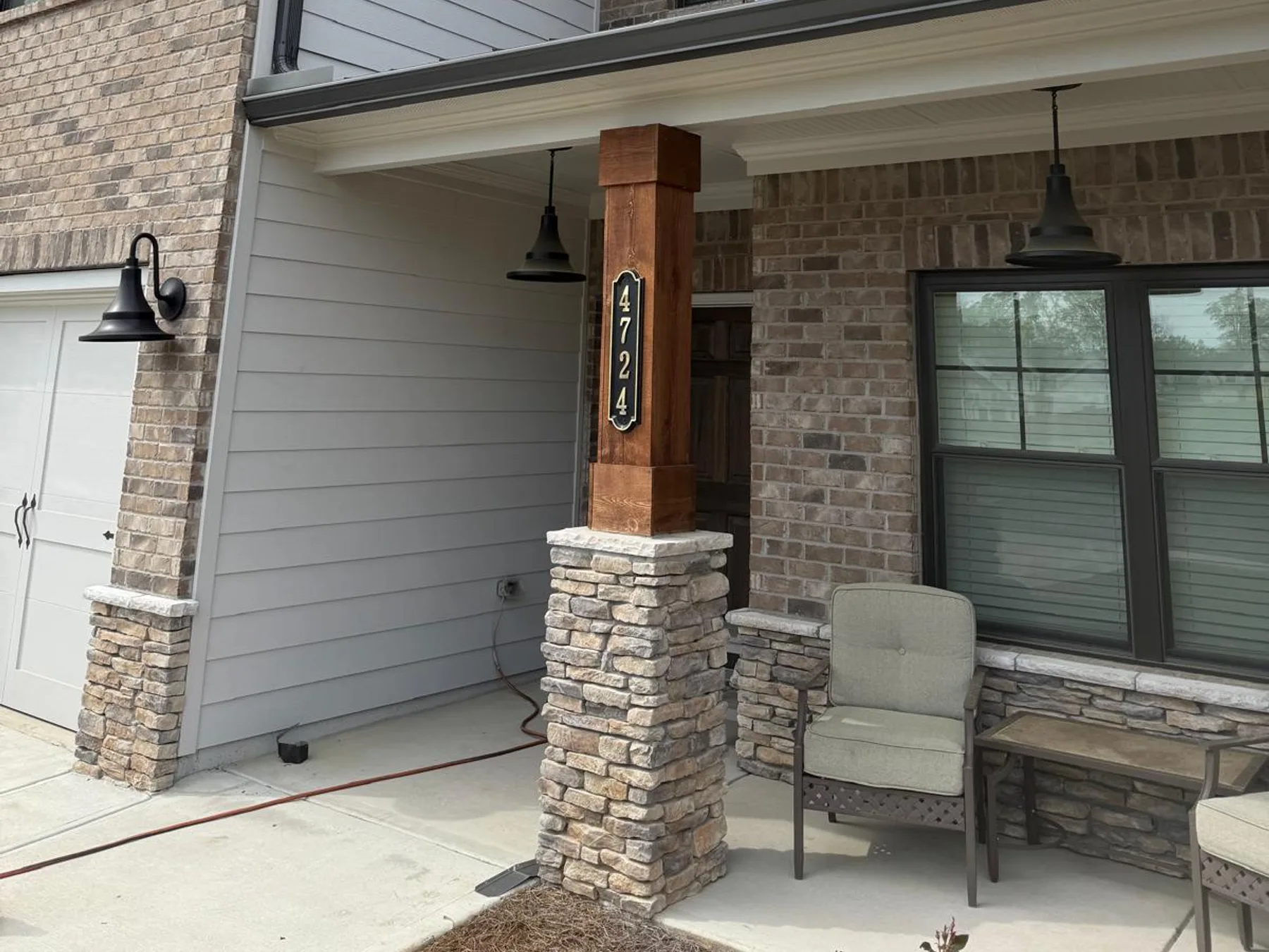 Completed gutter installation on a two-story brick and siding home