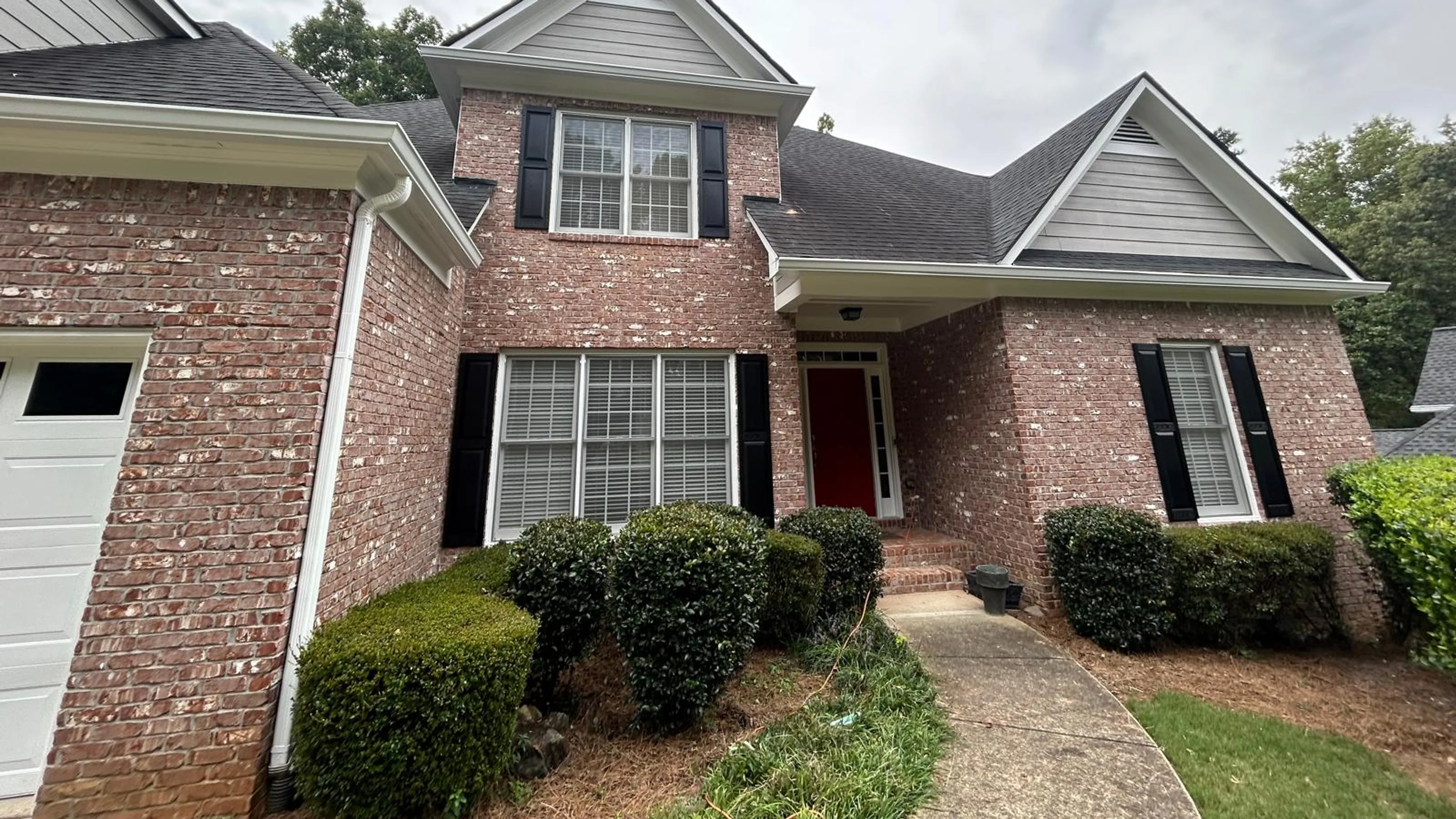 AJ Gutters technician installing seamless gutters on a residential home in Marietta GA